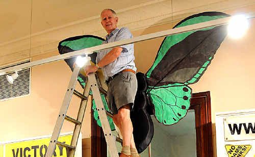 HIGH: Gallery volunteer Brian Hanson balances at the top of the ladder. HIGH: Gallery volunteer Brian Hanson balances at the top of the ladder.